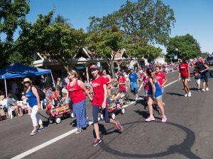 The Drop Daddies' families walking the parade route